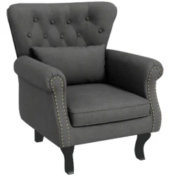 Dark grey tufted wingback armchair with pillow.