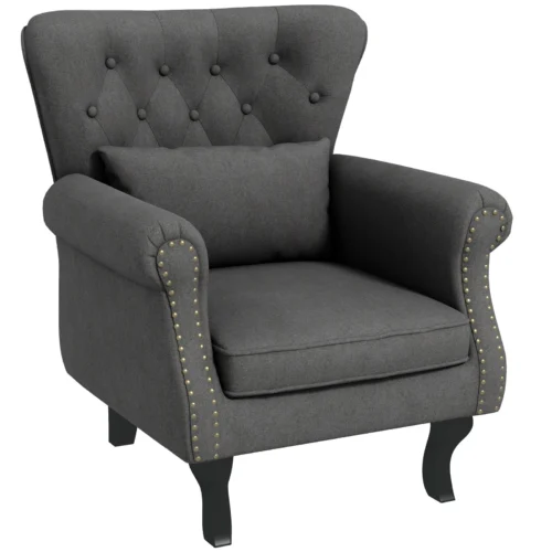 Dark grey tufted wingback armchair with pillow.