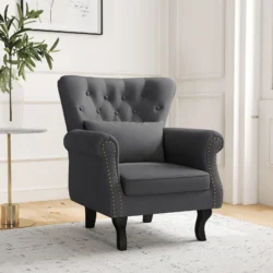 Chesterfield-style dark grey armchair with tufted back in a bright room.