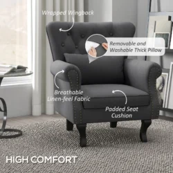 Dark grey Chesterfield-style armchair with tufted wingback and pillow.