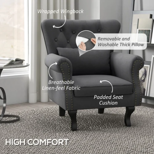 Dark grey Chesterfield-style armchair with tufted wingback and pillow.