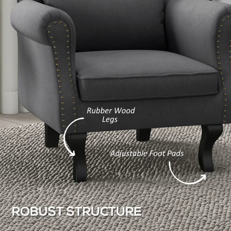 Close-up of a dark grey Chesterfield-style armchair with wooden legs.