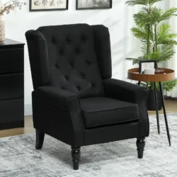 Black tufted wingback armchair in a living room with a side table and plant.