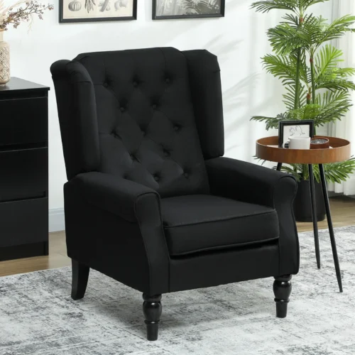 Black tufted wingback armchair in a living room with a side table and plant.