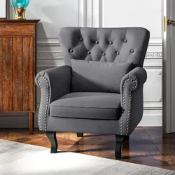 Dark grey Chesterfield-style accent chair with tufted back and pillow.