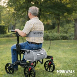 Person using MobiWalk SIT-RIGHT Rollator Walker in a park.