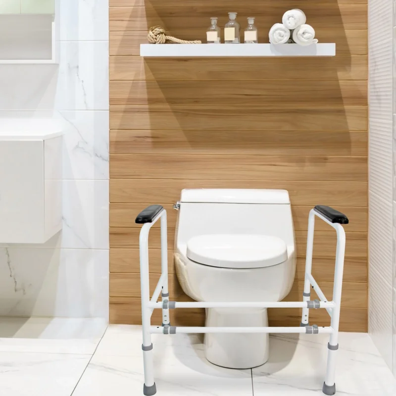 Toilet frame support with padded handrails around a toilet.