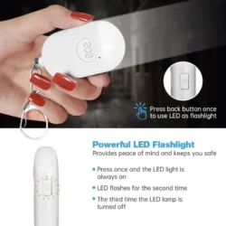 Hand holding a white personal alarm with SOS button and keychain.