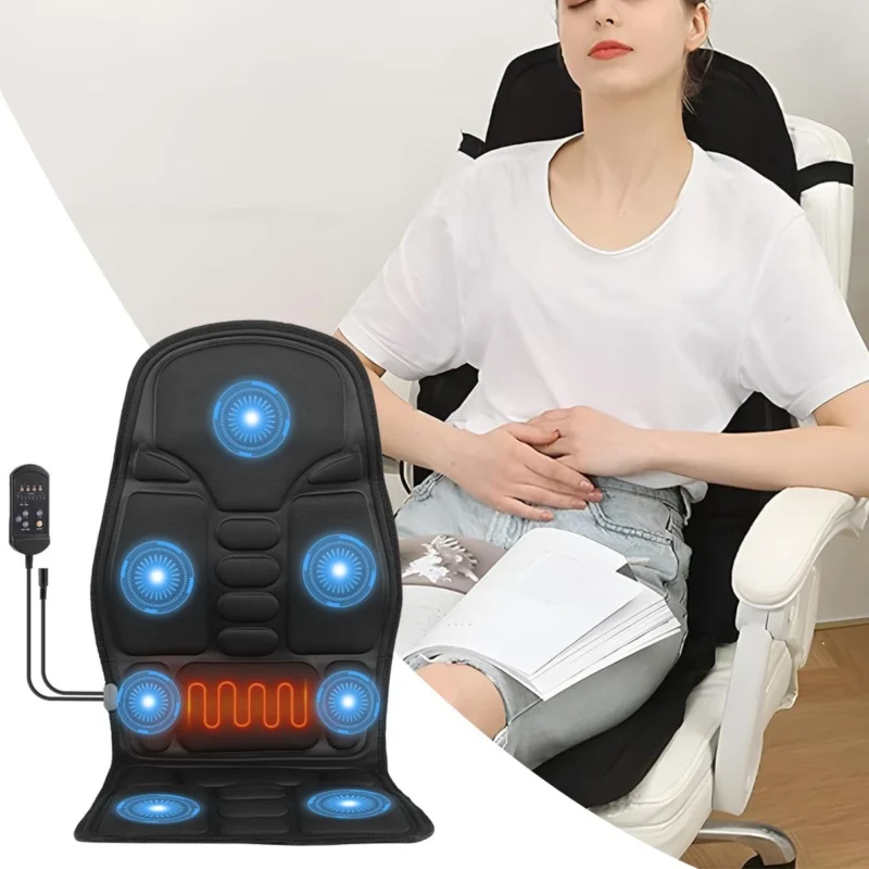 Person using a heated massage seat cushion on a chair with a remote control visible.