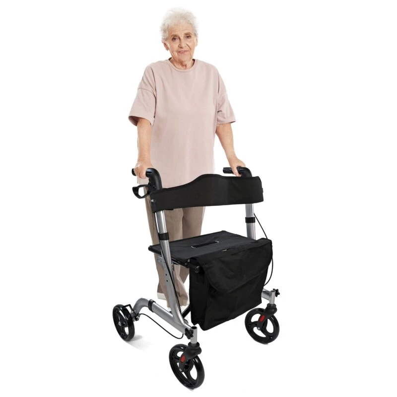 Elderly person using a lightweight foldable rollator with seat and bag.