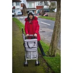 Woman walking along a pavement with the Regal shopping trolley