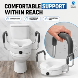 Hand gripping the soft foam armrest of a raised toilet seat with supportive handles