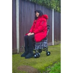Woman sitting on the Sovereign lightweight shopping trolley