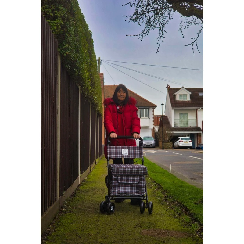 Woman pushing the Sovereign shopping trolley along a path