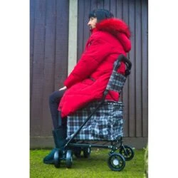 Side view of a woman resting on the Sovereign trolley seat with backrest