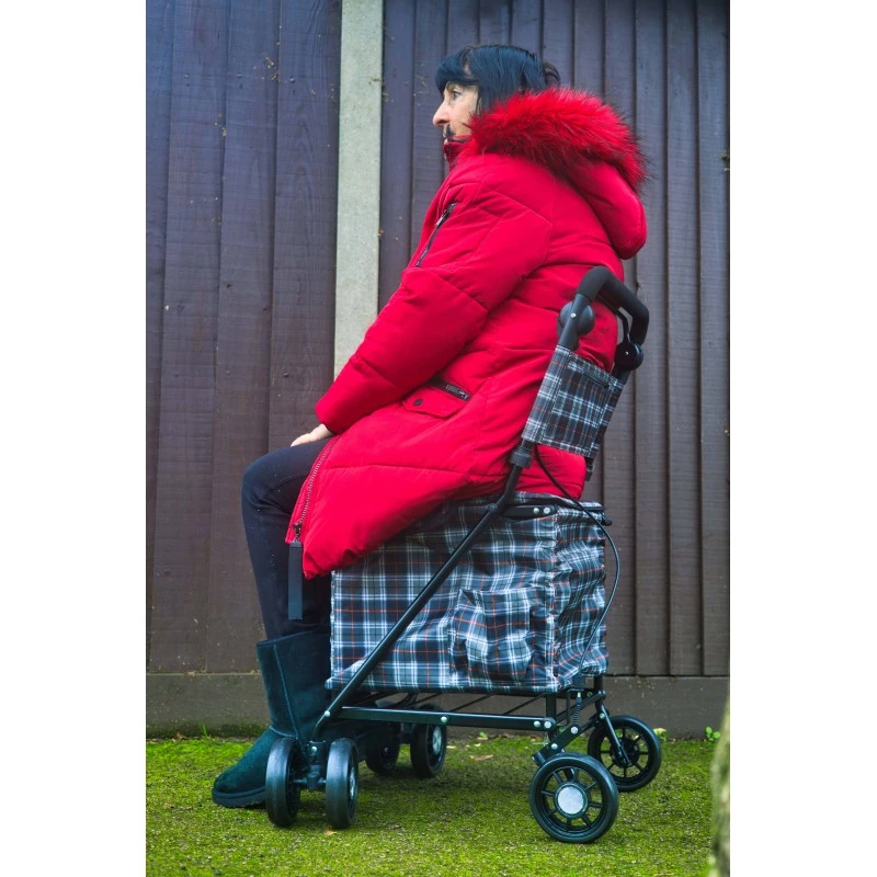 Side view of a woman resting on the Sovereign trolley seat with backrest